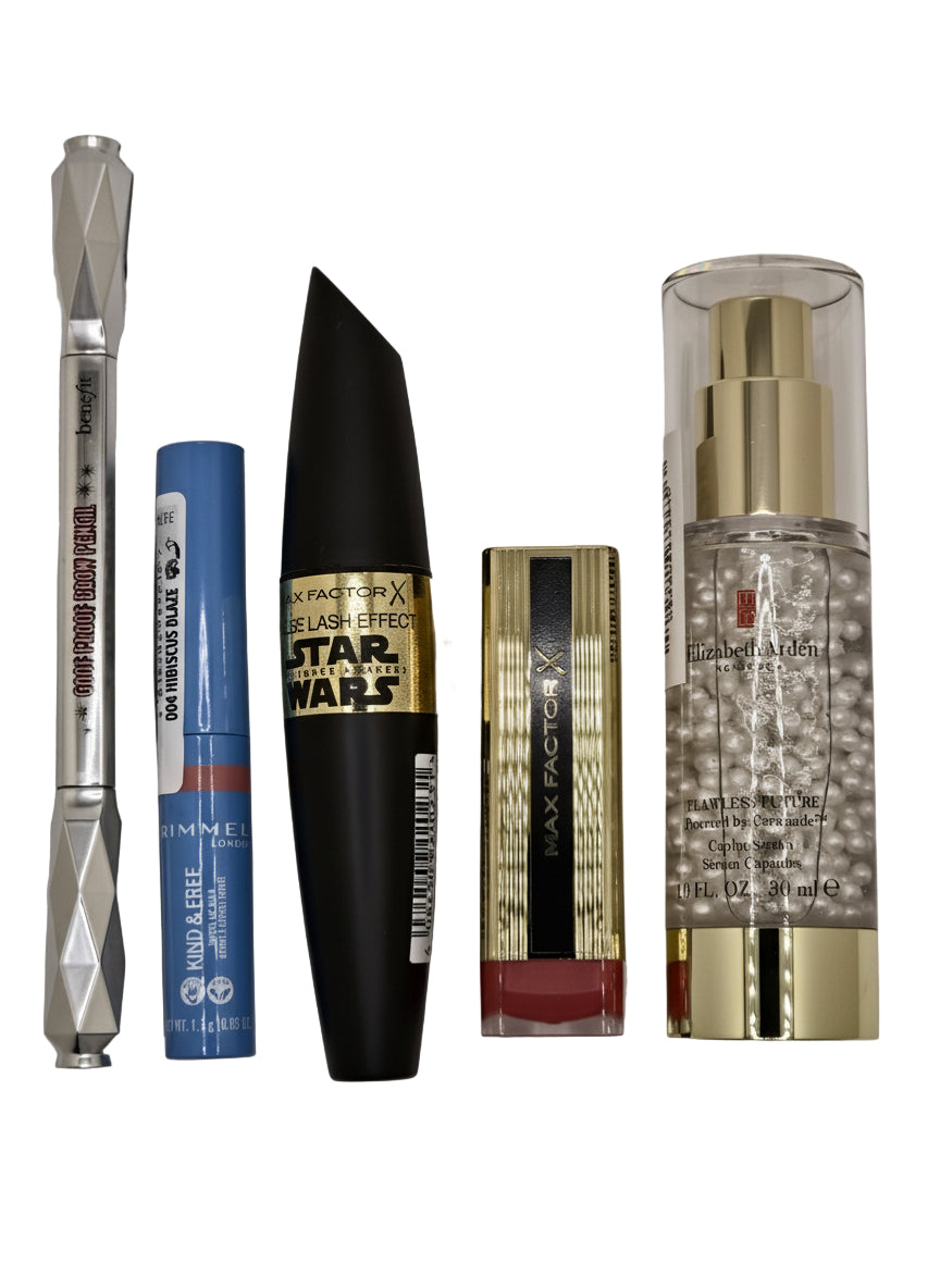 Collection of makeup products including a mascara, lip gloss, and serum on a gray background