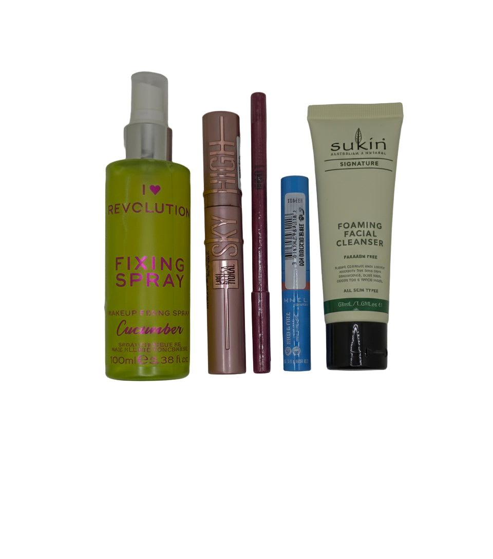 Collection of makeup and skincare products on a plain background